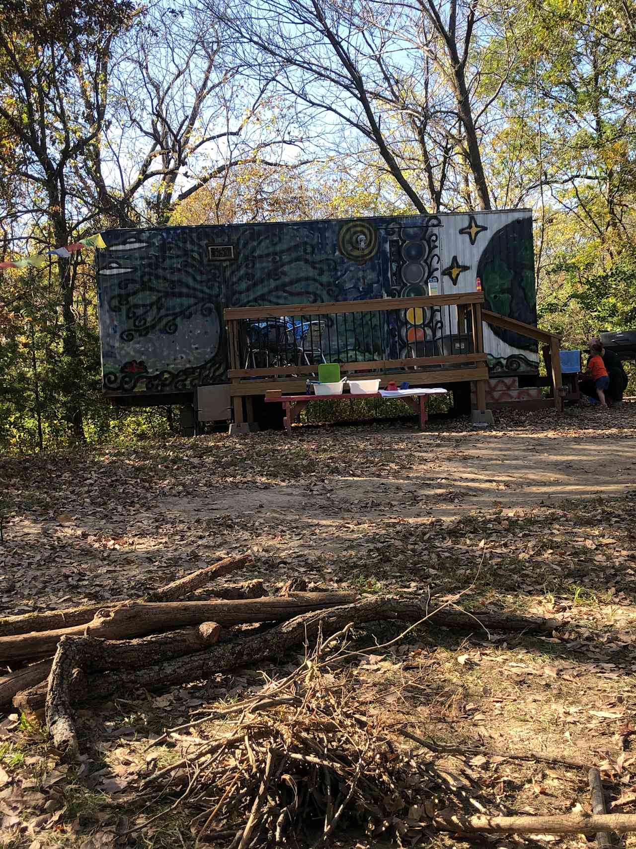Front view of Hippie Trailer and deck from the fire pit area