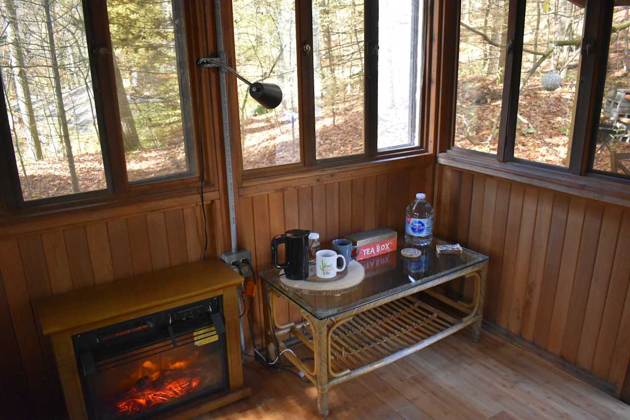 Coffee table with tea kettle and tea bags for your convenience.