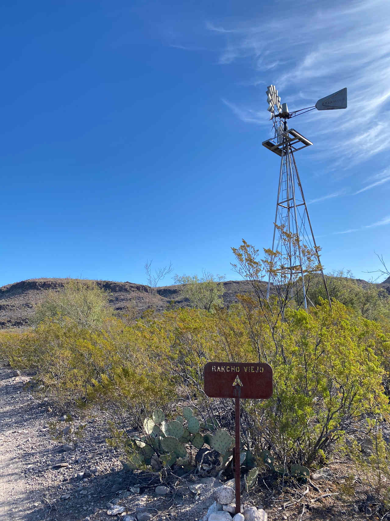 The windmill and old water trough are just to the left of the fire pit and table. 