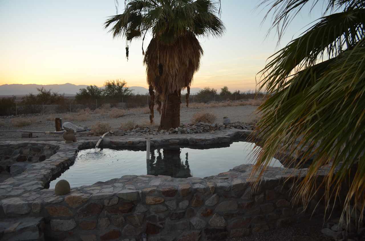 Rock lined soaking pool, filling up at 120 degrees