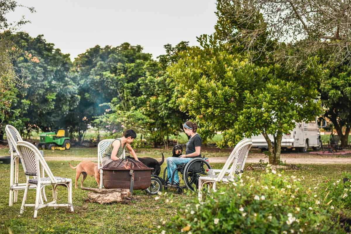 There is a communal raised fire pit with chairs around it for campers to use