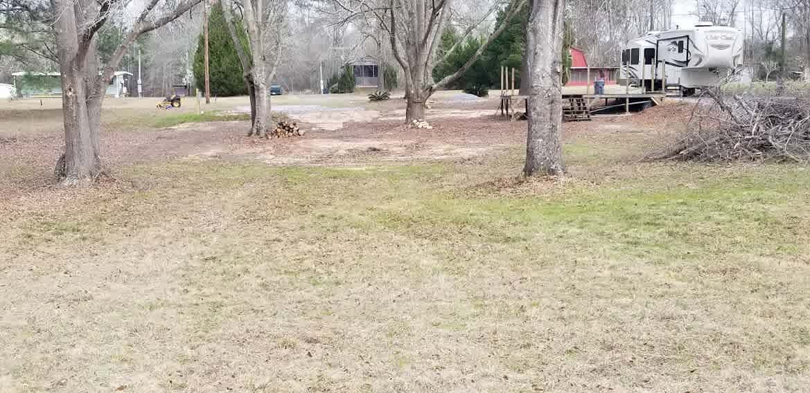 Campsite pic from the back of the lot. Even though there are other residences on this road, it is still very private, peaceful, and quiet.  The other RV is ours, however, most of the time we will not be there if the other site is booked. 
