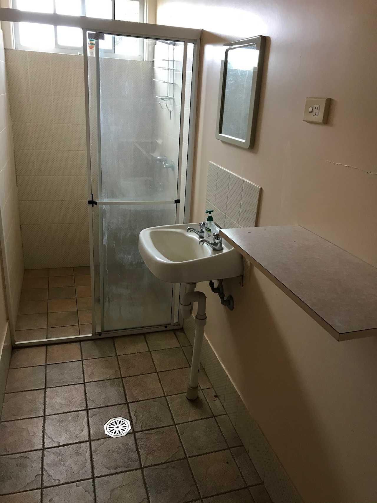 Shower with bench and power outlet, mirror.
Clean and tiled