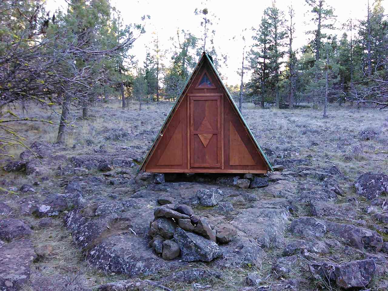 This is the "wooden tent" microcabin, about 250ft across the field from the Snugshack. An available included sleeping option for parties with more than two people.