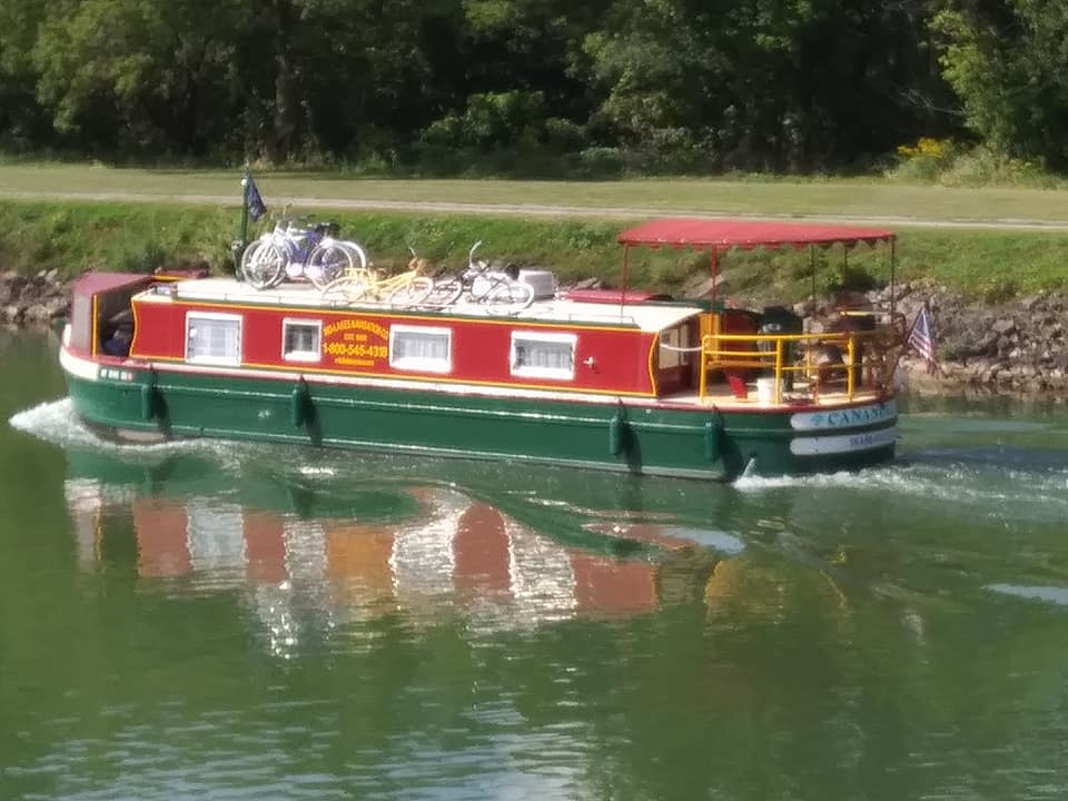 These are rental boats from the otherside of Rochester. 
It has a kitchen / bathroom and includes the bikes you see on it. You drive the boat yourself. 
I can share the info.