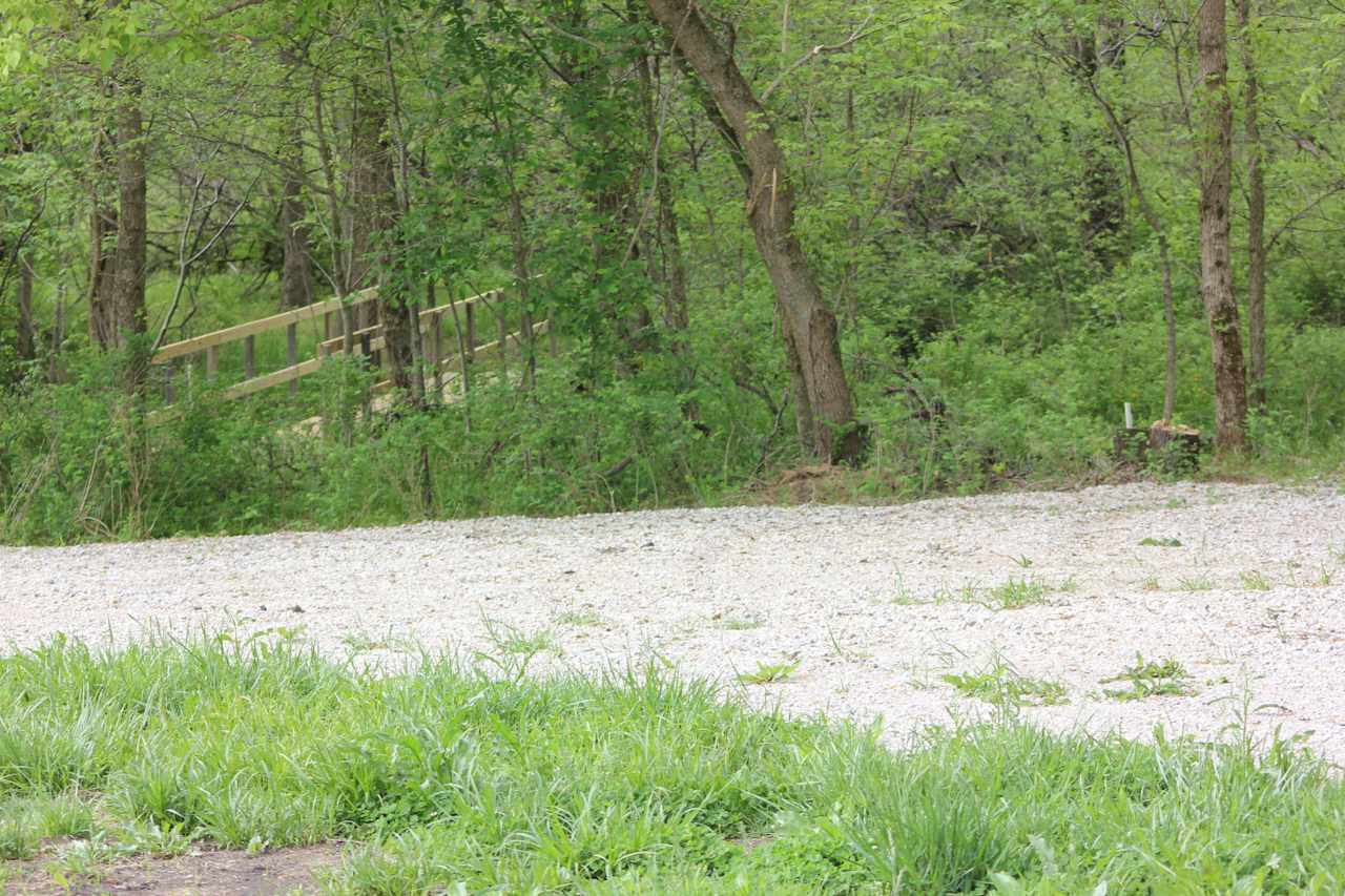 RV parking with bridge leading to clearing.