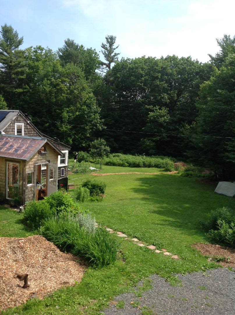 Tent platform is behind the house in the woods. It is 12’ x 11’ 8 inches.