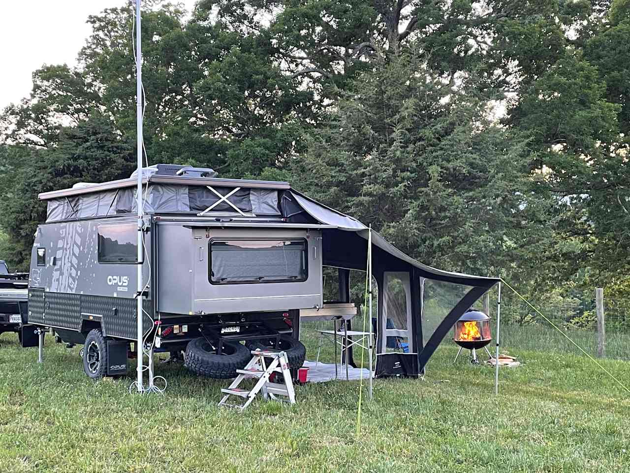 No hookups, just a spot in an open field, but with the firepit and the trees along the fence (and the nearby picnic table) it has a nice cozy campsite feel.