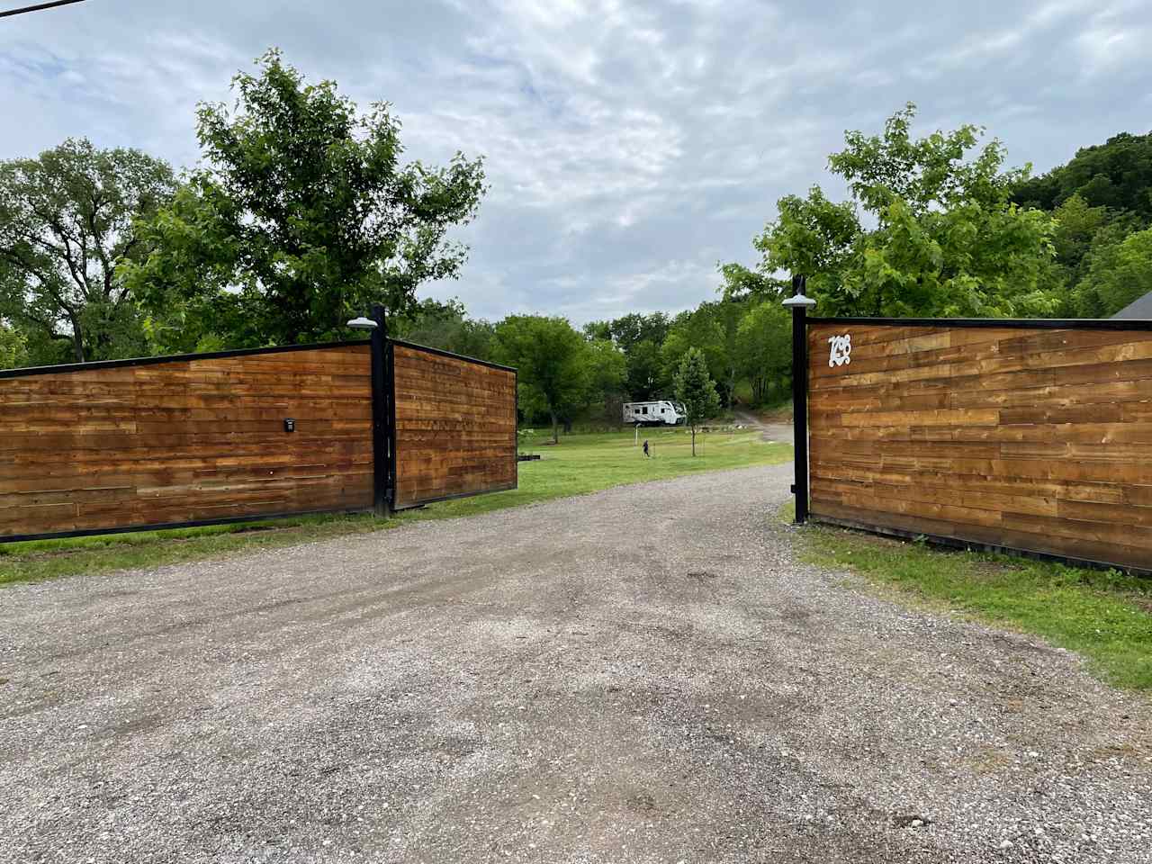 Southern facing view of gate and driveway. 

(Our personal RV pictured, so you can see how an RV looks in the space.)