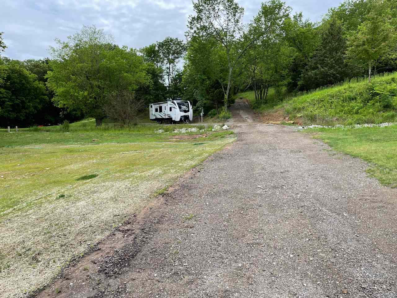 Southern facing driveway view of RV site.

(Our personal RV pictured, so you can see how an RV looks in the space.)