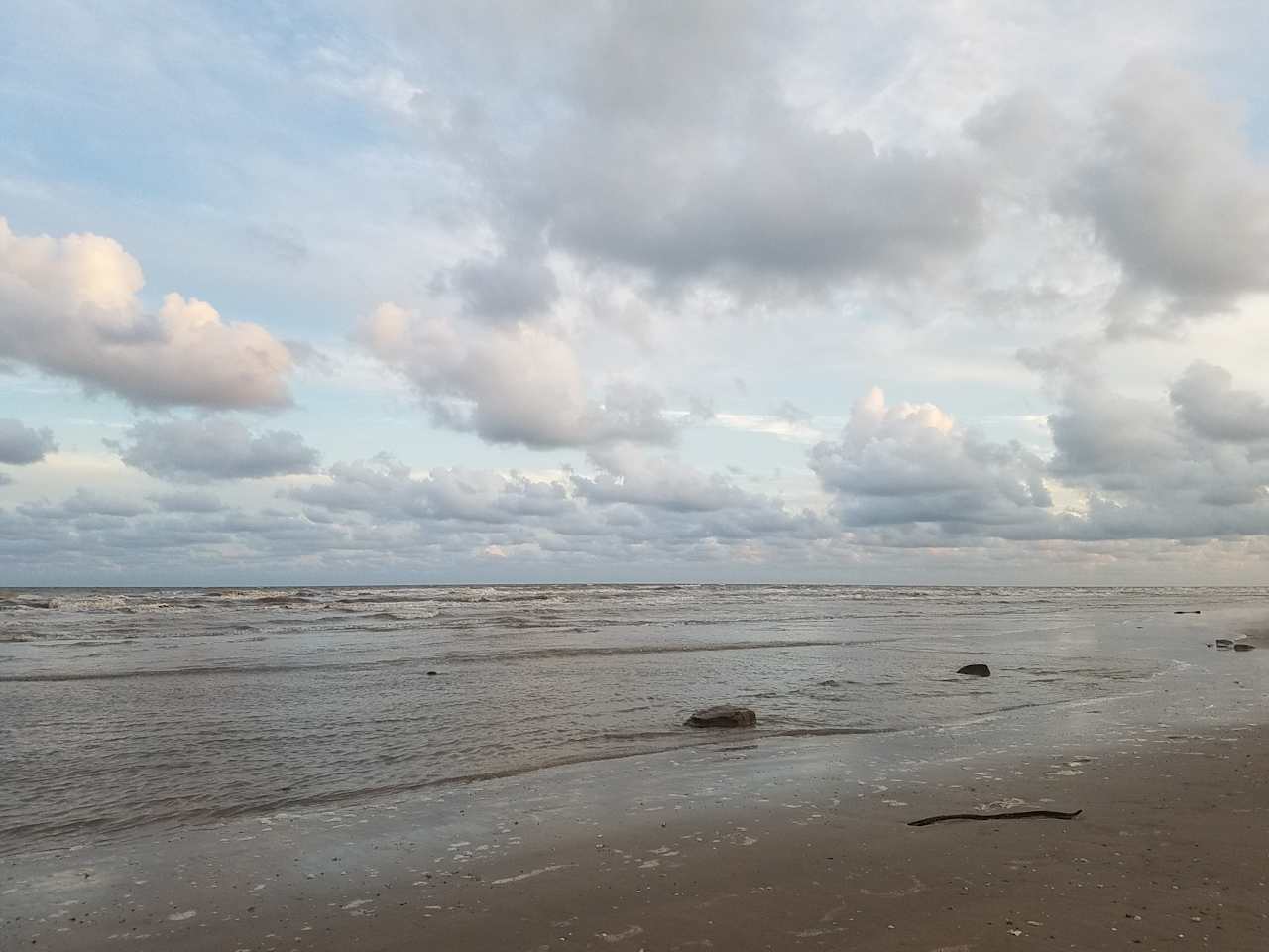 Nothing better than a cold drink, surf, and puffy clouds!