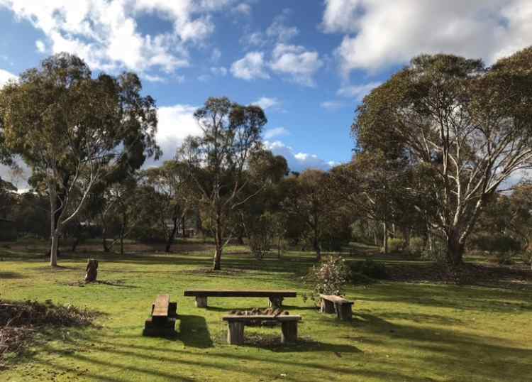 Fireplace with quadrangle seating in front of campsites 1 and 2