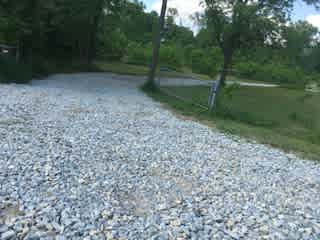 Enter through the gravel drive off the road near the bridge.