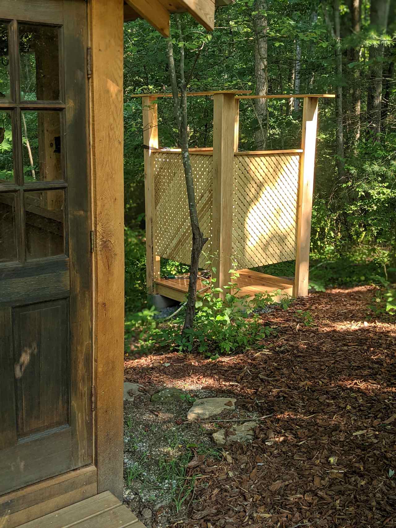 Shower stall adjacent to the outhouse.