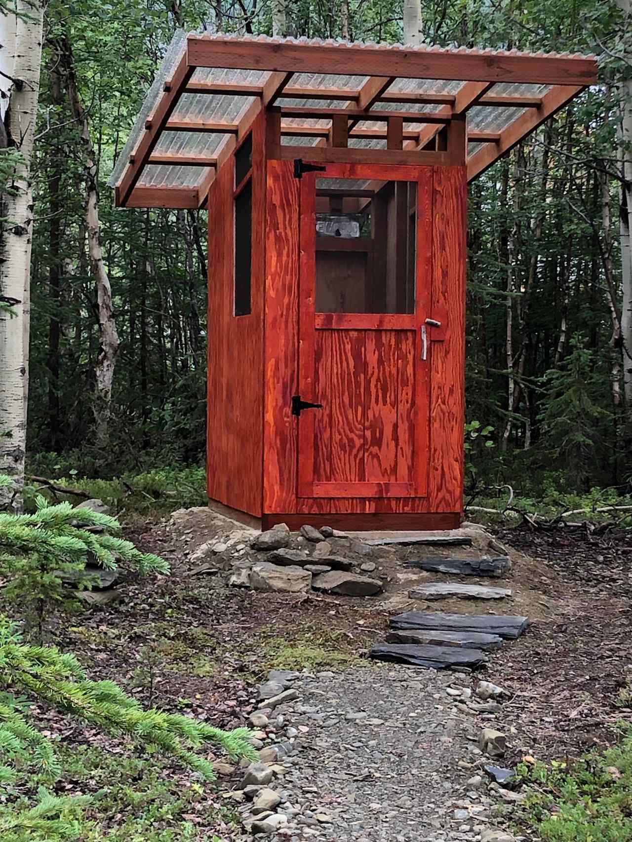 One of Alaska's finest and cleanest outhouses nicknamed "The Igloo." See if you can spot the 1960's era Igloo water cooler nearby.