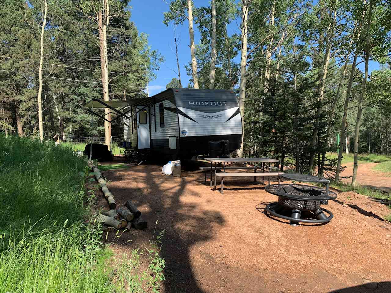 RV, gravel driveway, picnic table, firepit, firewood. BBQ grill near the RV awning but we didn’t do any grilling.