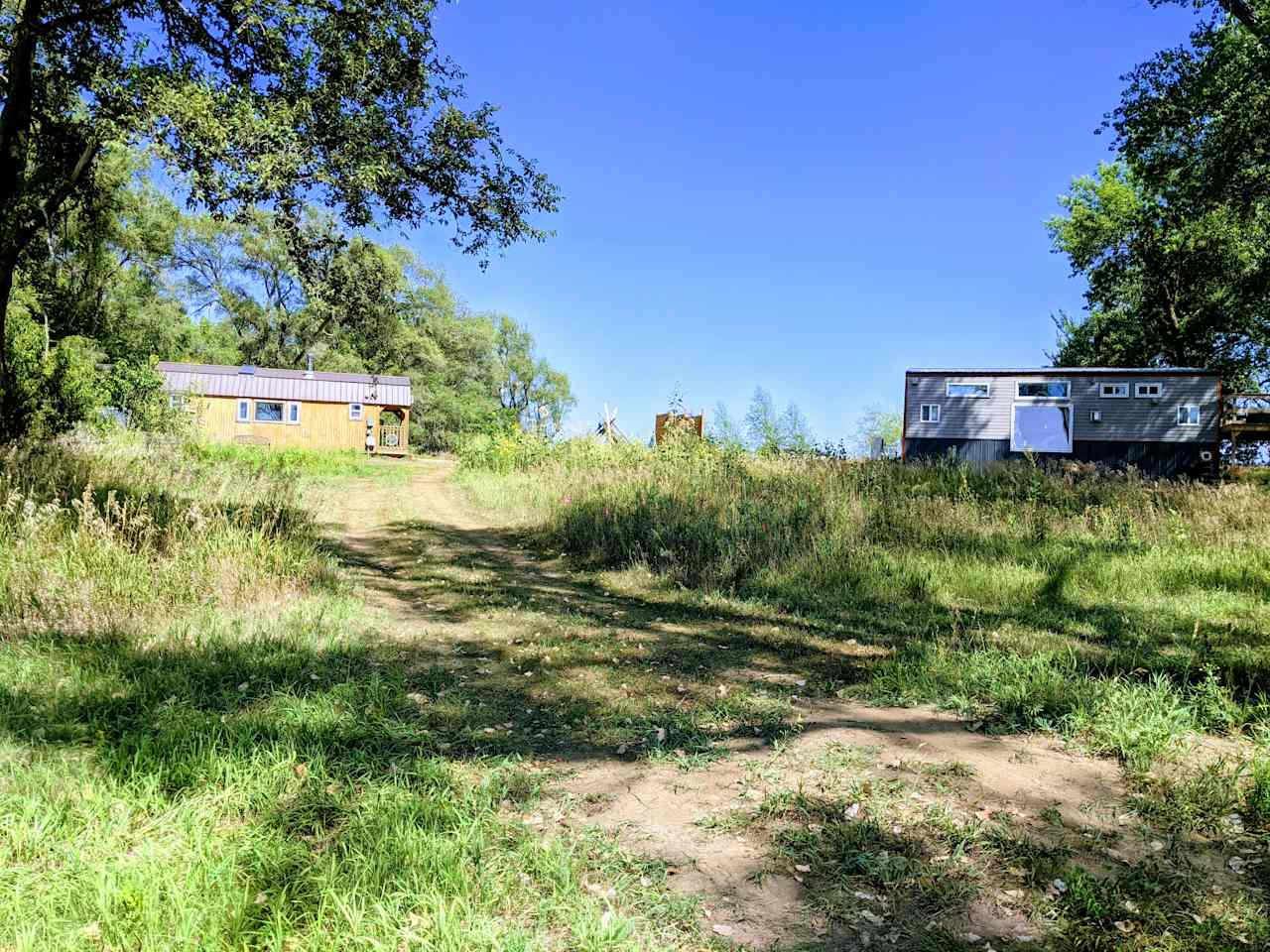 There's 3 tiny houses in this area but this is a picture to show you how close the grey one is to where you will stay