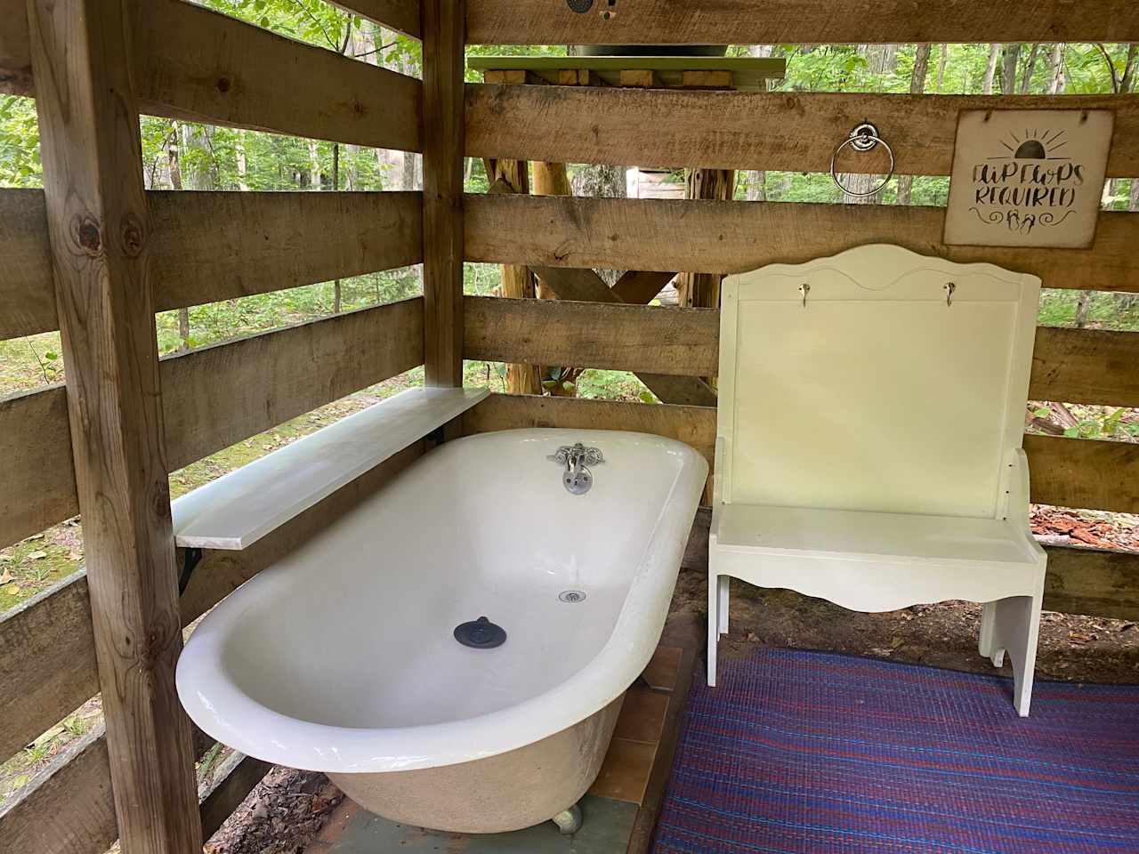 Seasonal outdoor cold shower in the woodshed. 