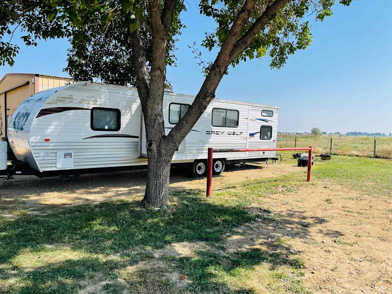 32 ft trailer w/slideout parked next to garage