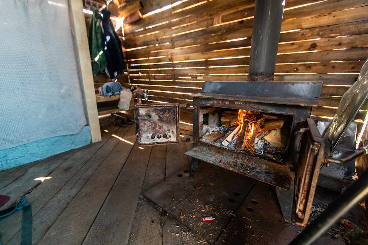 The "Unfinished" shower hut. Such a strong AMAZING vibe! There's a fire place to heat up on cold days.