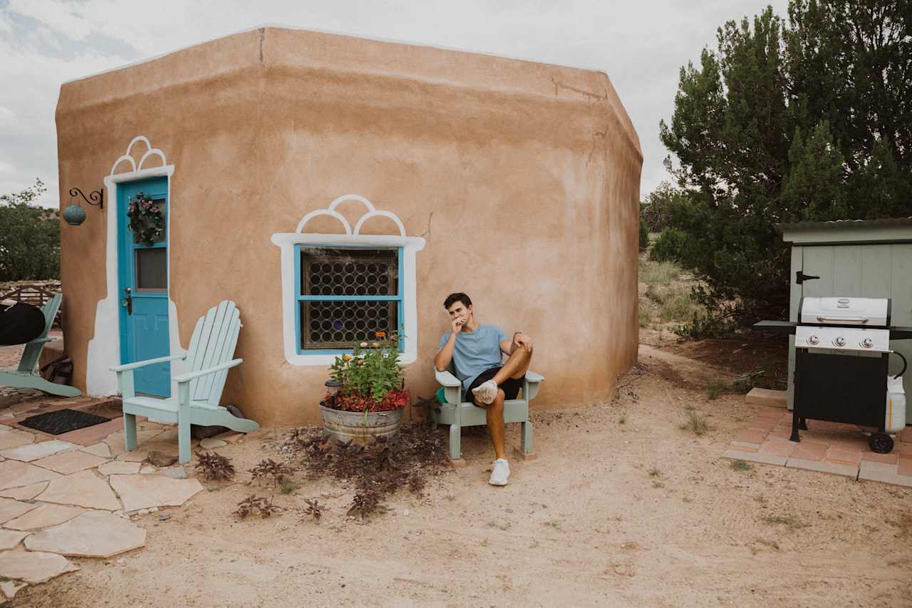 The hogan's outdoor features were designed by the late owner. Besides being detailed, there are several functional spaces. The original bench, several sitting areas, and a grill are all on the property. 