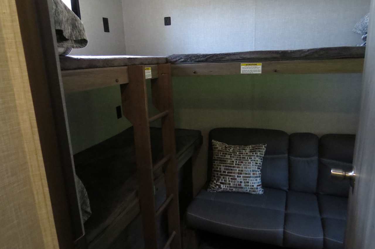 Bunk room has three single beds and a couch that turns into a full size bed.