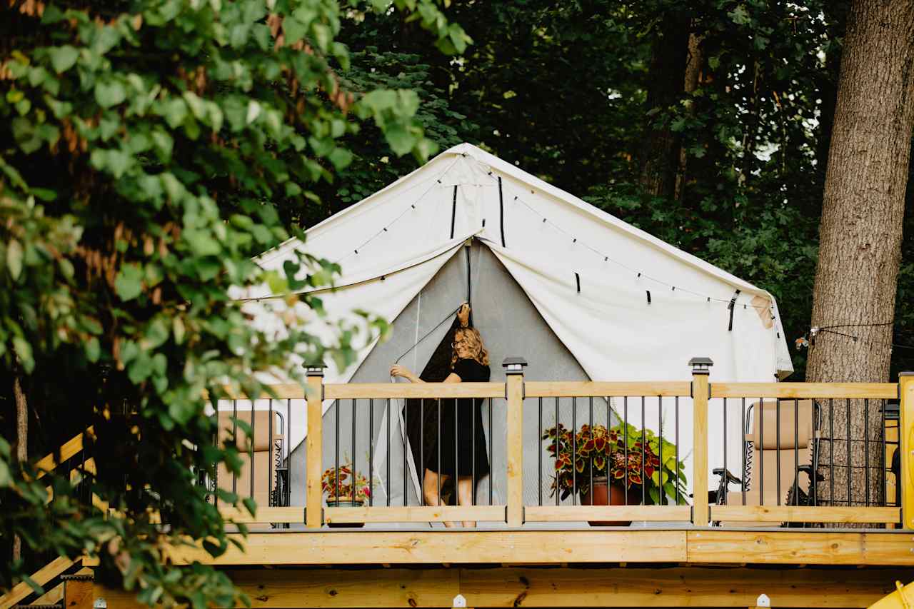 The tent is up a short flight of steps with a nice deck that contains the hot tub, chairs, hand washing station, and slide.