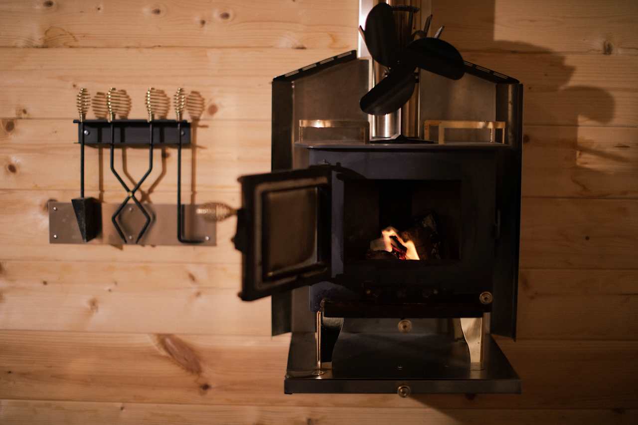 Inside the cabin, as the temperature drops, this mini wood burning stove was my favourite addition to the cabin. It was easy to use, warmed us up, and obviously cute to look at.