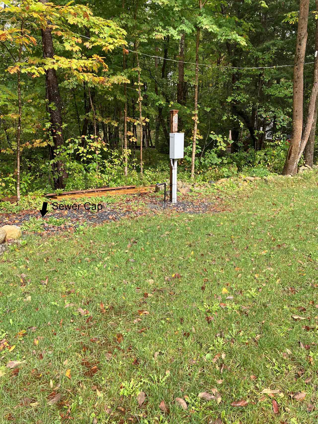 Water, electric, sewer connections at Site 3 (note the arrow for sewer).