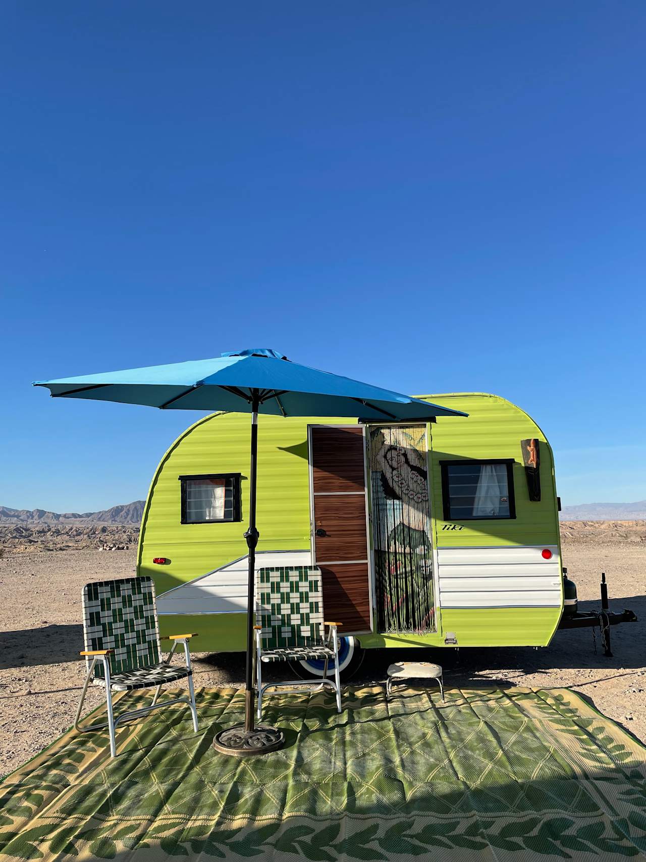 Return to the tiki lounge of yesteryear ! The Tiki is a vintage 1961 Northwest Coach travel trailer. The Tiki, with a second chance at life, was rescued and inspired by a 1950’s tiki lounge. Feel the tropic vibes with hints of bamboo palm walls & tiki torches. Provides full size bed and seating area for two. 