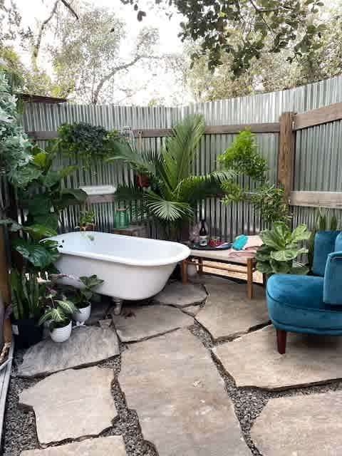 Our bathroom area is divided. The tub and shower are outside and the toilet and sink are indoors.