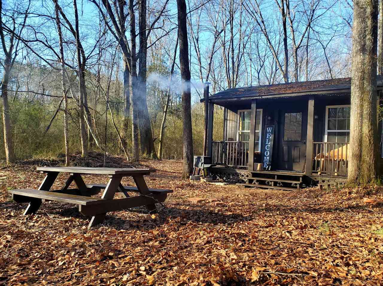 Cabin Jewelle with it's own picnic bench burning a campstove fire