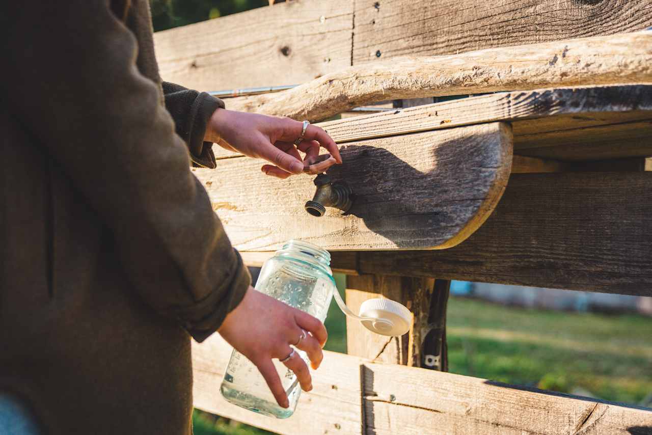 A tap is available at the upper field, along the garden fence line. 