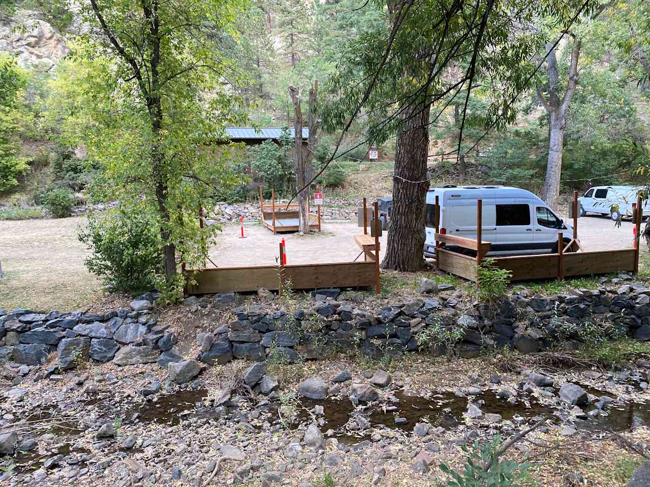 Vanlife campsite with creekside deck