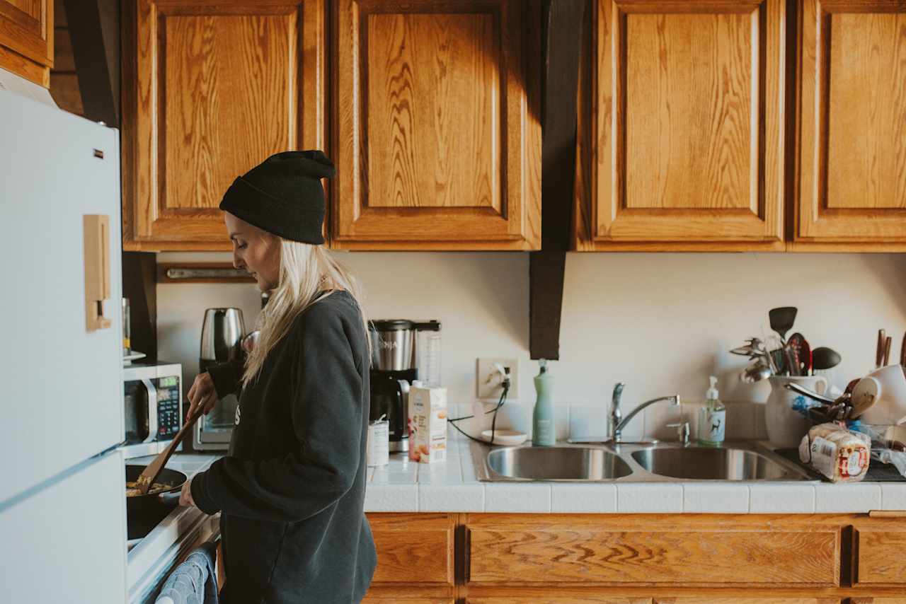 The kitchen is stocked with pots, pans, spices, etc.