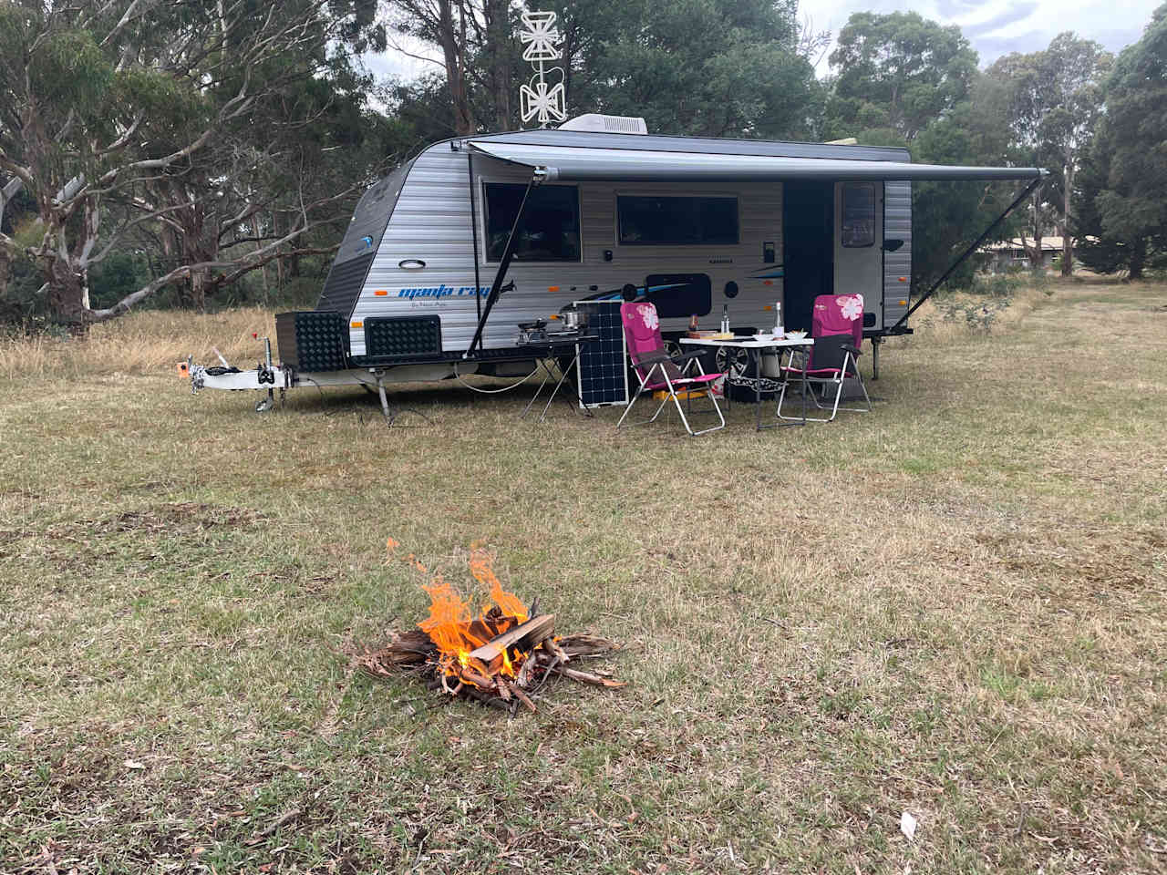 Evening camp fire with a glass of Vino