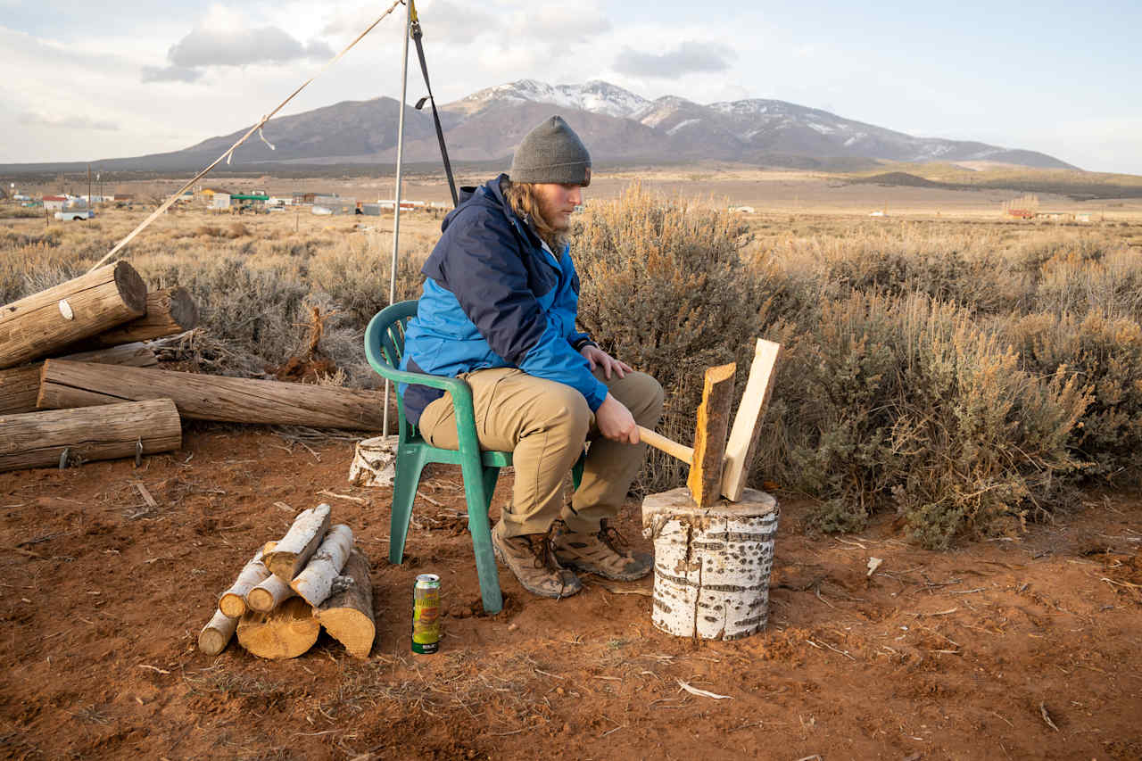 Chopping wood to make a fire. Firewood, axes, chopping stumps, and fire pits are all provided!