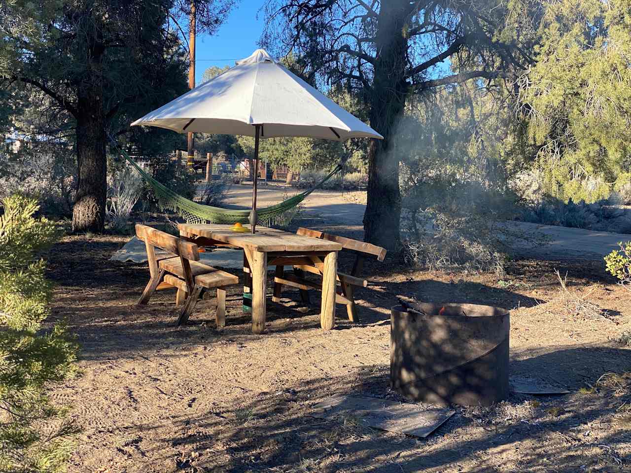 Steel ring fire pit, large picnic table, hammock spot under the large piñon pines. 