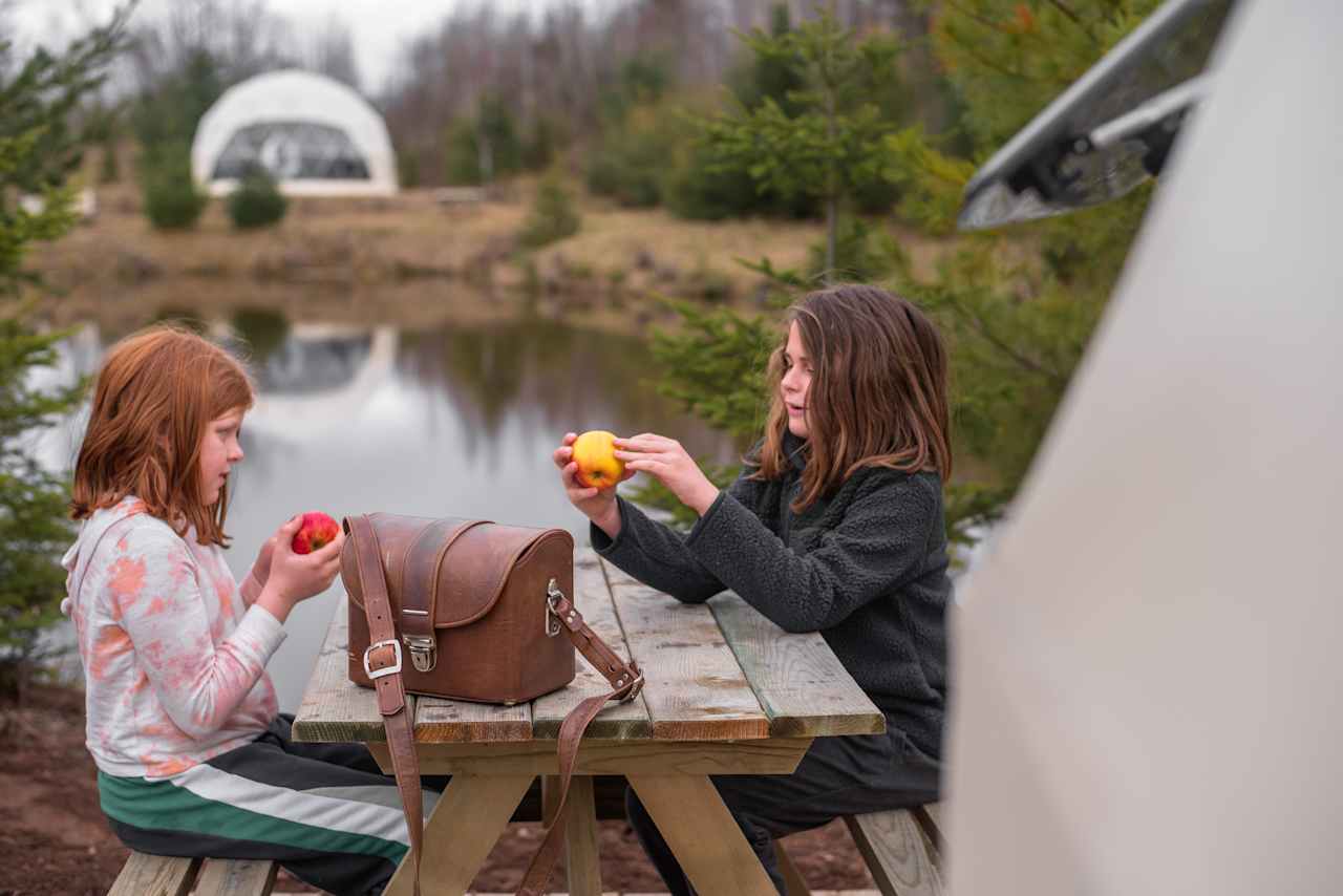 Kids sitting by the water for a snack