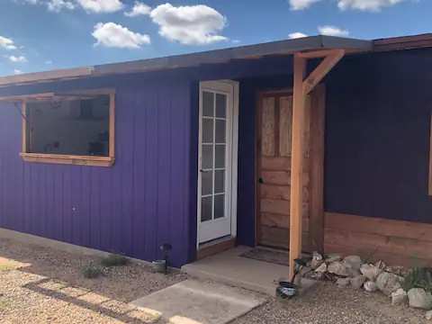 Note it is quirky - two entrances. The white door is to the kitchen/bathroom and wooden door is to living and sleeping area.