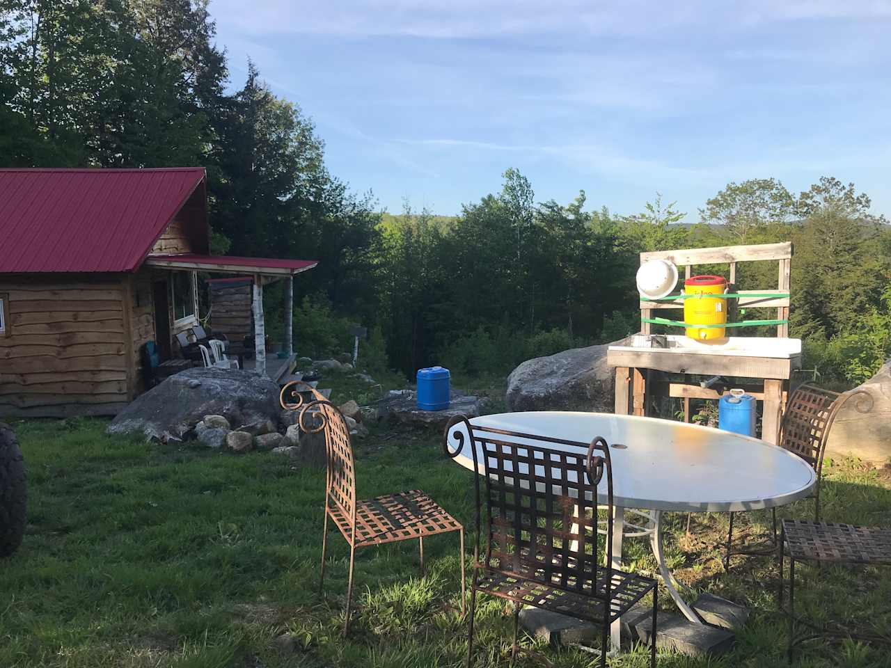 Kitchen area with fire pit, sink for washing your dishes, plenty of water and seating area.