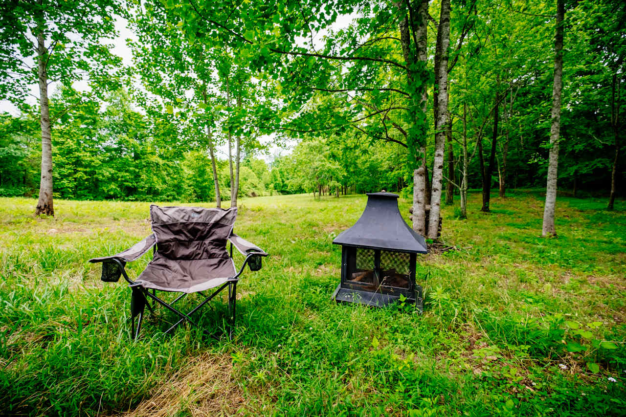 Outdoor fireplace & provided camp chairs 