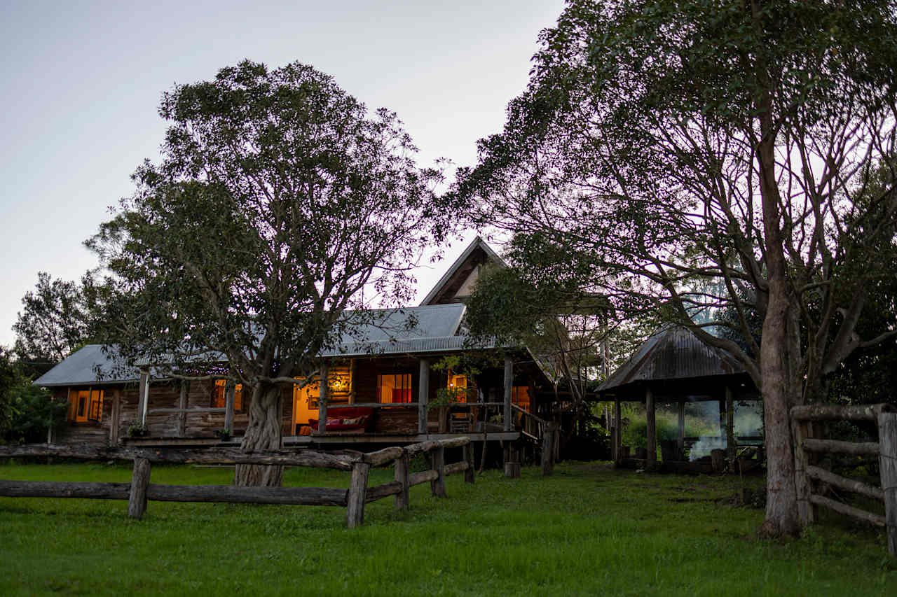 The ranch at sunset with a fire burning. 