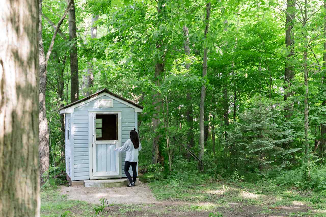 The outhouse is a refurbished chicken coop. Good ventilation and battery-operated pot lights inside for nighttime use. 