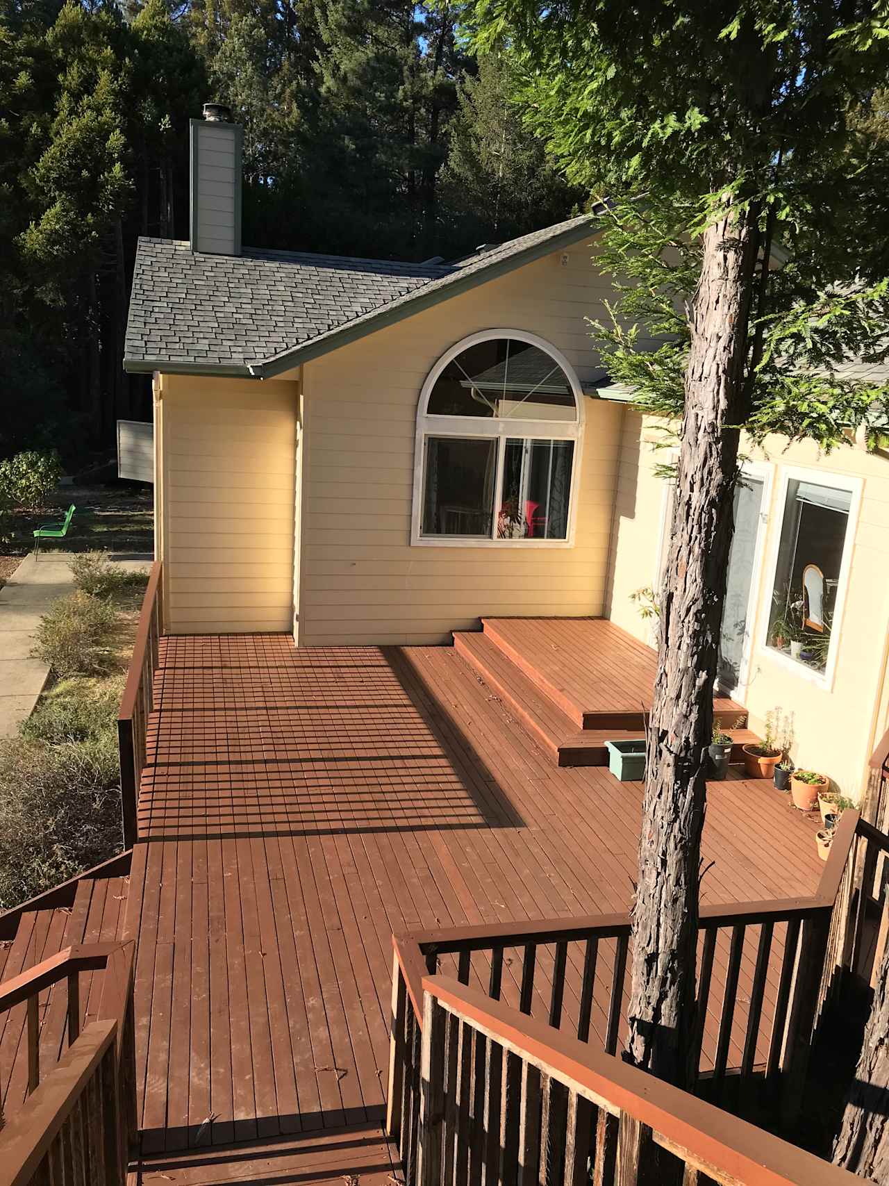 View coming down from the front door. There is a flight of stairs as the treehouse is on the second level. There are beautiful views of the trees all around, hence the name treehouse. 