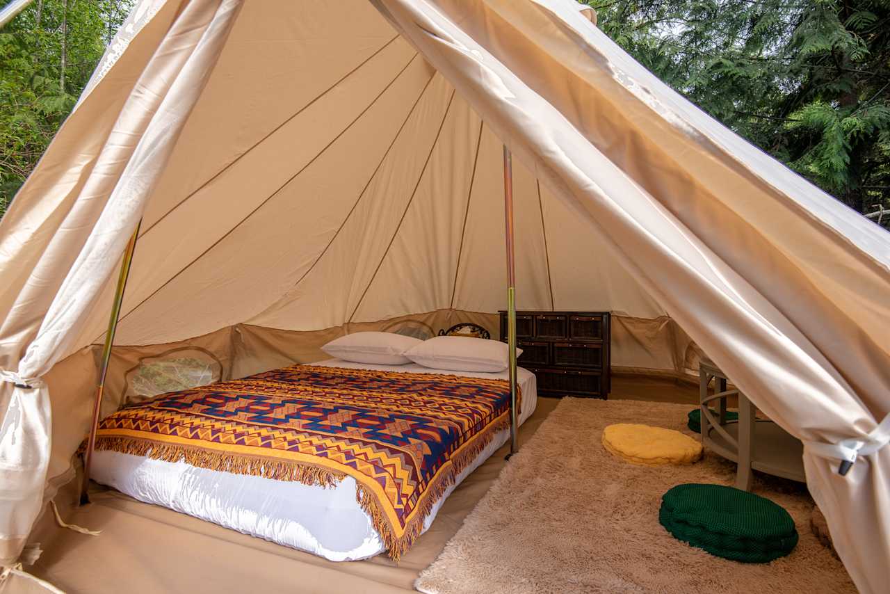 Amazing space inside the tent - big bed, a cute little table with floor cushions and a set of wicker drawers to stow away clothes and gear.