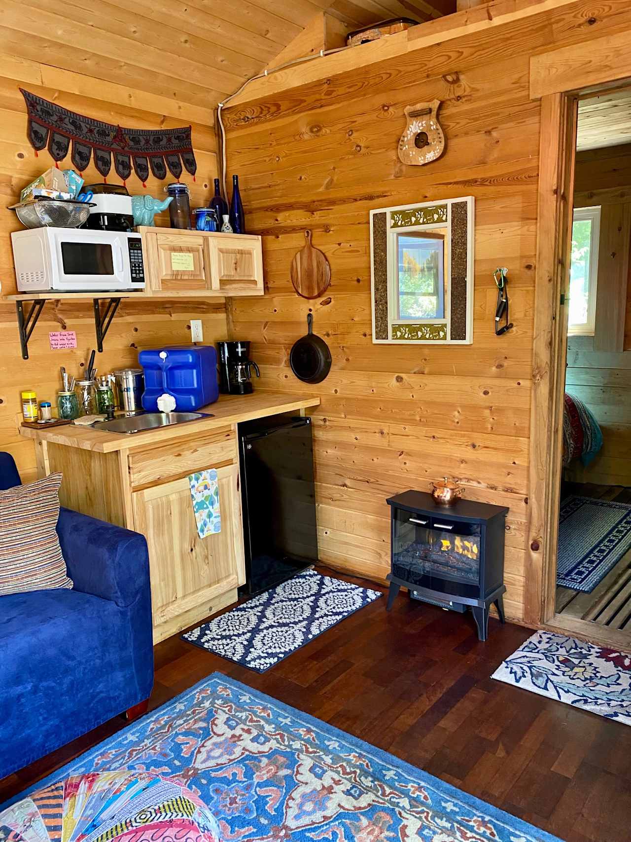 Small kitchen area with electric heater/fireplace.