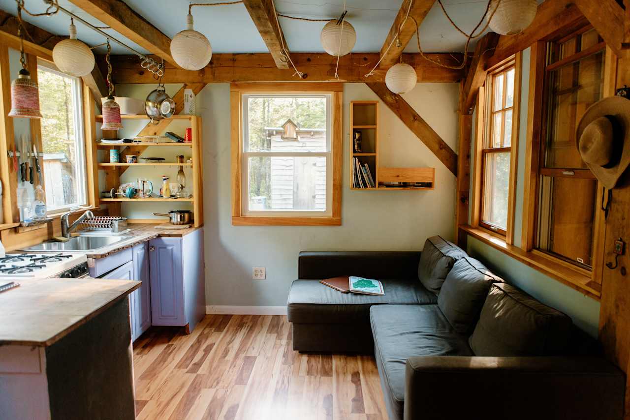 the lounge area and kitchen in the tiny house; view from the main entrance