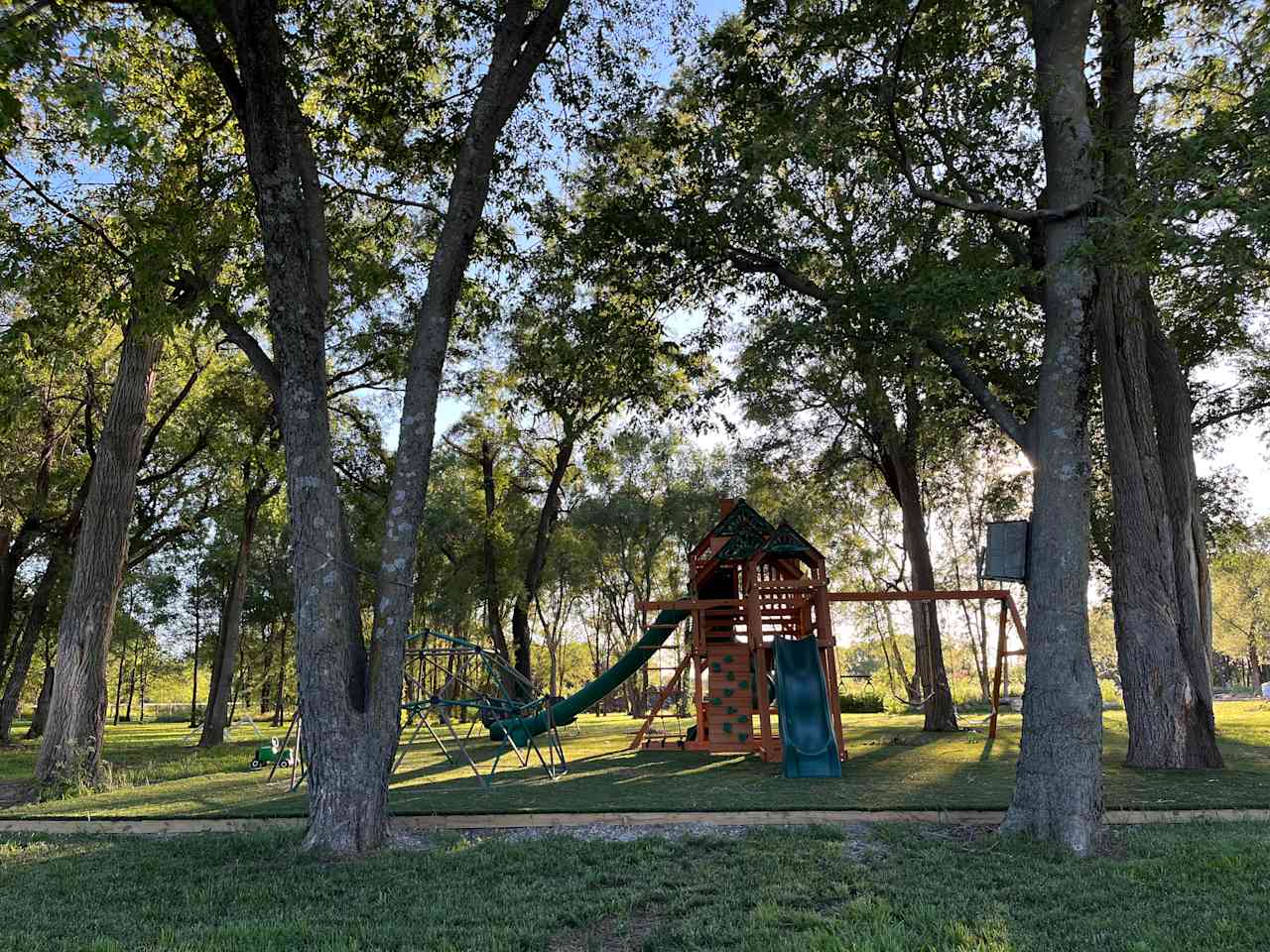 The playground tucked in the trees. Photo was taken in early June. Shared space.