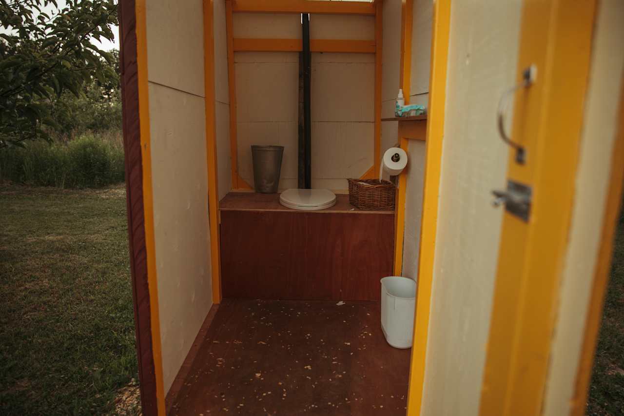 A beauty outhouse near enough to the tent to make a run for it in the night-time but not close enough that you lose any privacy!